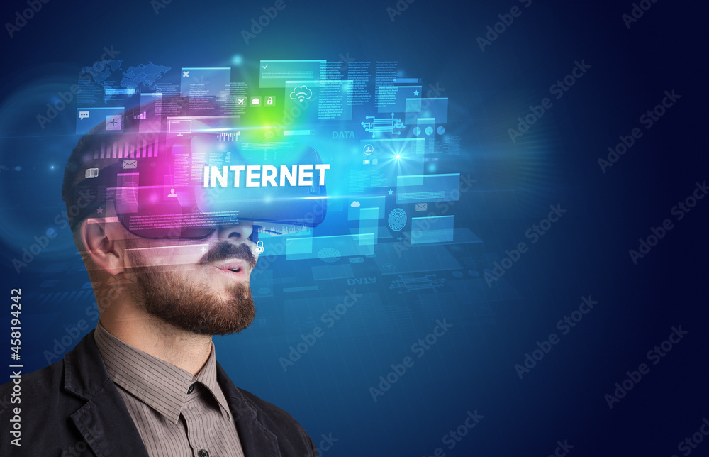 Businessman looking through Virtual Reality glasses Businessman looking through Virtual Reality glasses