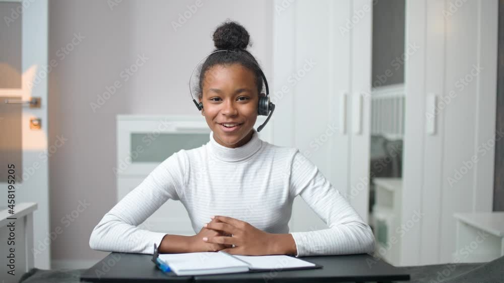 Distance learning and homeschooling online, african teen girl uses a videocall and webcam to studying during a pandemic, remote learning at school. Distance learning and homeschooling online, african teen girl uses a videocall and webcam to studying during a pandemic, remote learning at school.