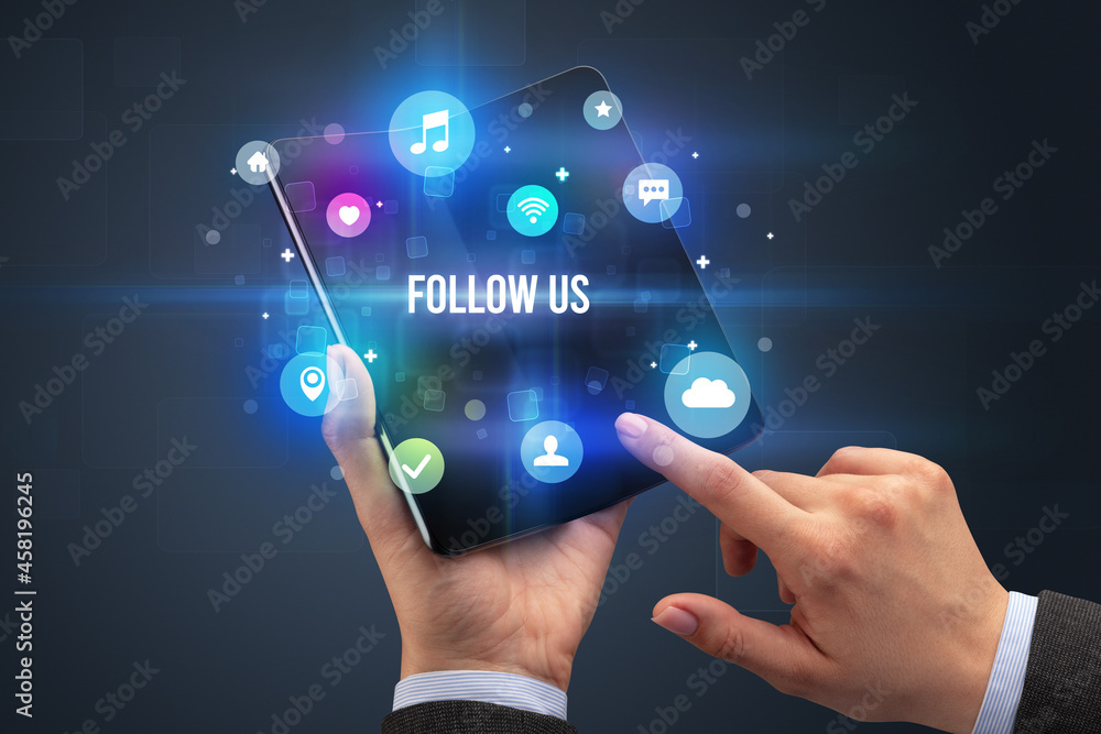 Businessman holding a foldable smartphone Businessman holding a foldable smartphone