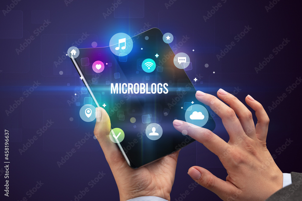 Businessman holding a foldable smartphone Businessman holding a foldable smartphone