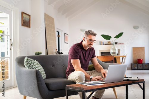 Mid adult business man working from home photo