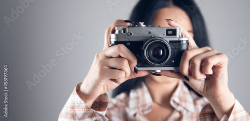 young woman holding vintage camera