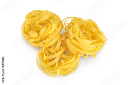 Raw tagliatelle pasta isolated on white background with clipping path and full depth of field. Top view. Flat lay