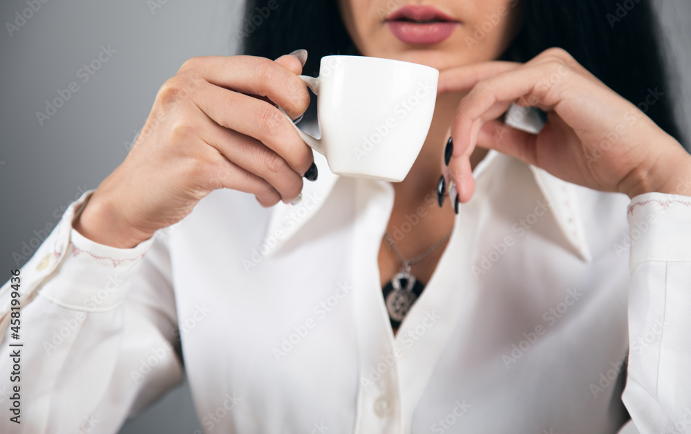 woman drinking coffee in office woman drinking coffee in office