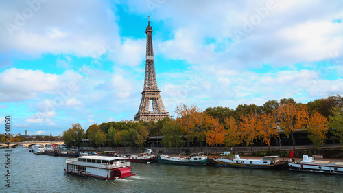 Banner of travel in Paris with Eiffel Tower iconic Paris landmark across the River Seine with tourist boat in Autumn tree fall scene at Paris ,France