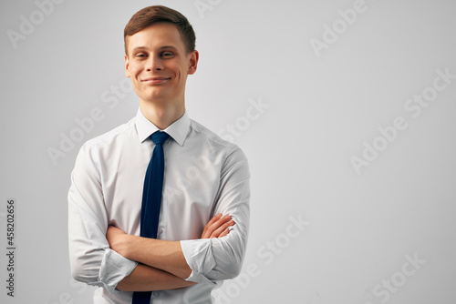 man in white shirt with tie gesturing with hands success emotions self-confidence