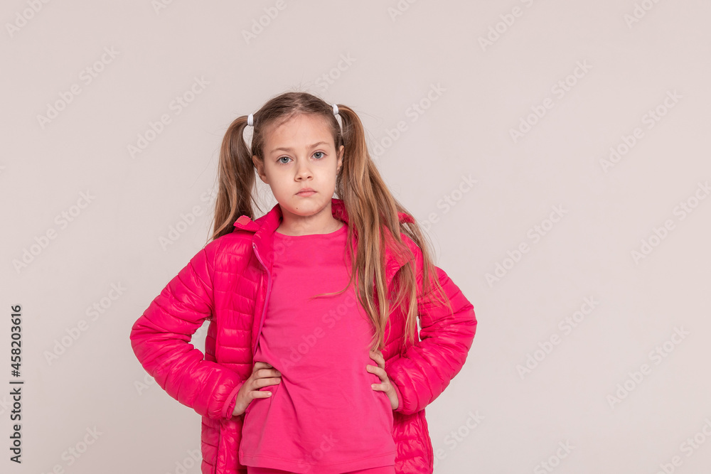 girl with tails on a white background. baby in a pink jacket girl with tails on a white background. baby in a pink jacket