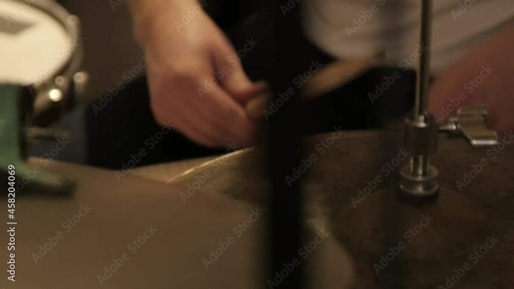 Drum kit getting played by a musician in a close-up. Drum kit getting played by a musician in a close-up.