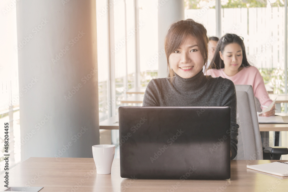 Asian business woman who sitting work by notebook in feeling happy at the office with daylight from window and blur garden background. Asian business woman who sitting work by notebook in feeling happy at the office with daylight from window and blur garden background.