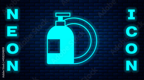 Glowing neon Dishwashing liquid bottle and plate icon isolated on brick wall background. Liquid detergent for washing dishes. Vector