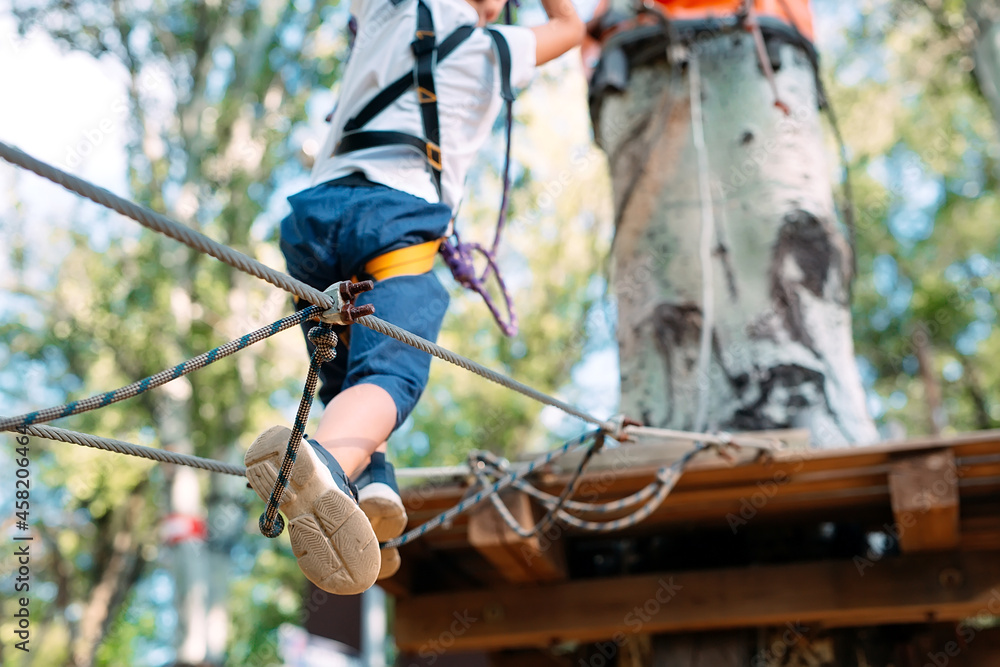 Rope Park. close - up of a child's feet passing an obstacle. Rope Park. close - up of a child's feet passing an obstacle.