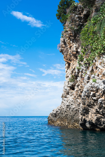 Wallpaper Mural Huge rock, blue sky and blue sea. Beautiful seascape. Vertical photography. Torontodigital.ca