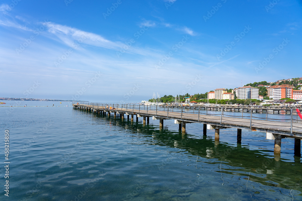 Portoroz central beach with pier and resort buildings