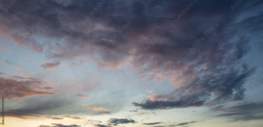 Naklejka premium Rain clouds in the sky at sunset