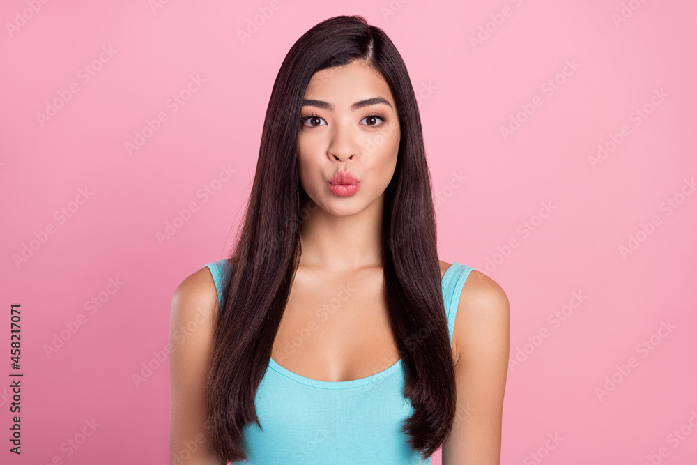 Photo of gorgeous young brown hairdo lady blow kiss wear blue top isolated on pastel pink color background Photo of gorgeous young brown hairdo lady blow kiss wear blue top isolated on pastel pink color background
