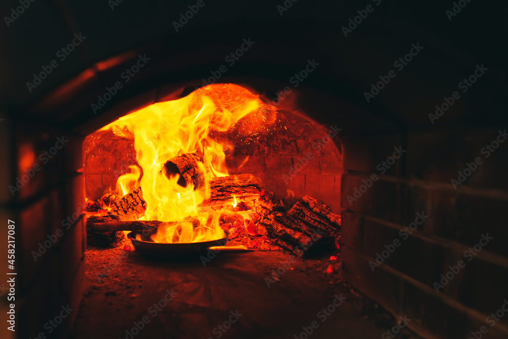 Cooking Steak in a stone oven.