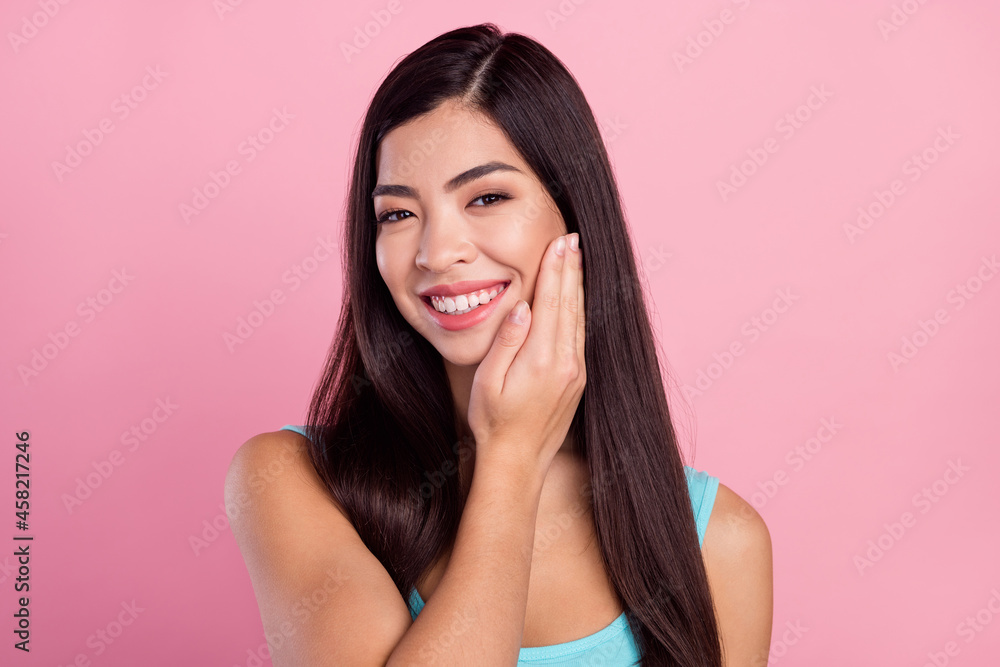 Photo of cute young brown hairdo lady apply cream wear blue top isolated on pastel pink color background Photo of cute young brown hairdo lady apply cream wear blue top isolated on pastel pink color background