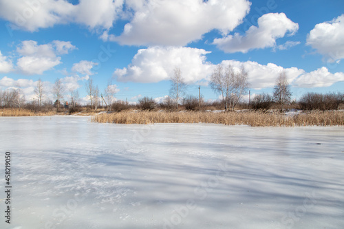 Frozen lake in winter and blue sky