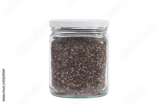 Chia in a transparent glass jar. Close-up. Isolated on white background.