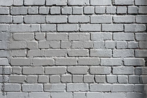 Old brick wall painted in white color.