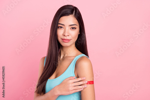 Photo of optimistic lady touch plaster wear blue top isolated on pink color background