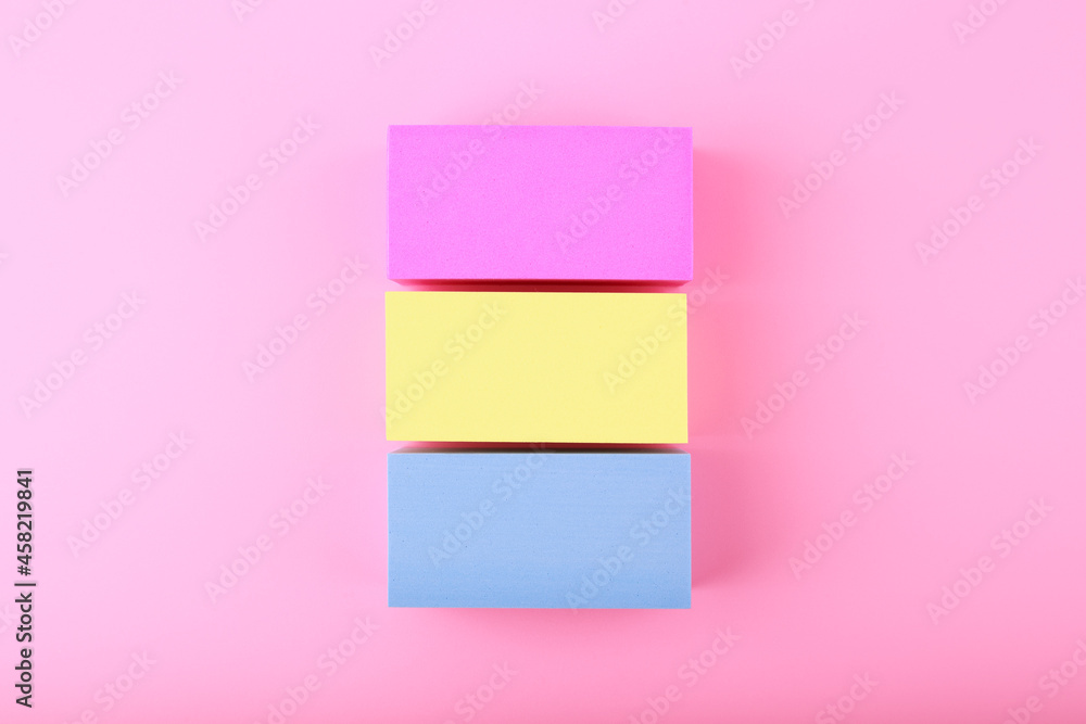 Flat lay with pansexual flag made of pink, yellow and blue rolls on bright pink background. Concept of pansexual community, sexual minorities, equal right and tolerance Flat lay with pansexual flag made of pink, yellow and blue rolls on bright pink background. Concept of pansexual community, sexual minorities, equal right and tolerance