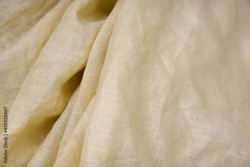 Yellow fabric cloth texture liquid silk texture of waves or wavy folds. 
background wallpaper design.  