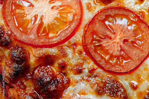 pizza Margarita close up with cheese and tomatoes.