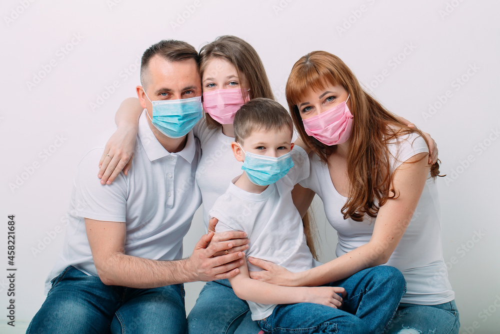 young family in medical masks during home quarantine. young family in medical masks during home quarantine.
