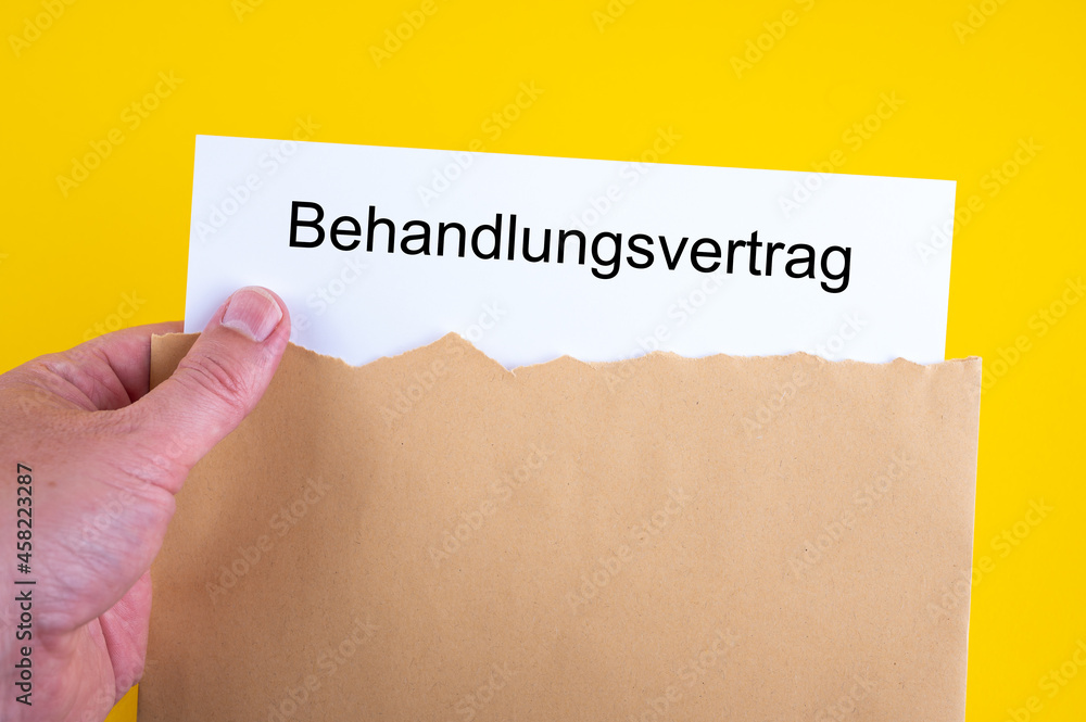 Eine Hand nimmt einen Behandlungsvertrag aus einem Briefumschlag Eine Hand nimmt einen Behandlungsvertrag aus einem Briefumschlag