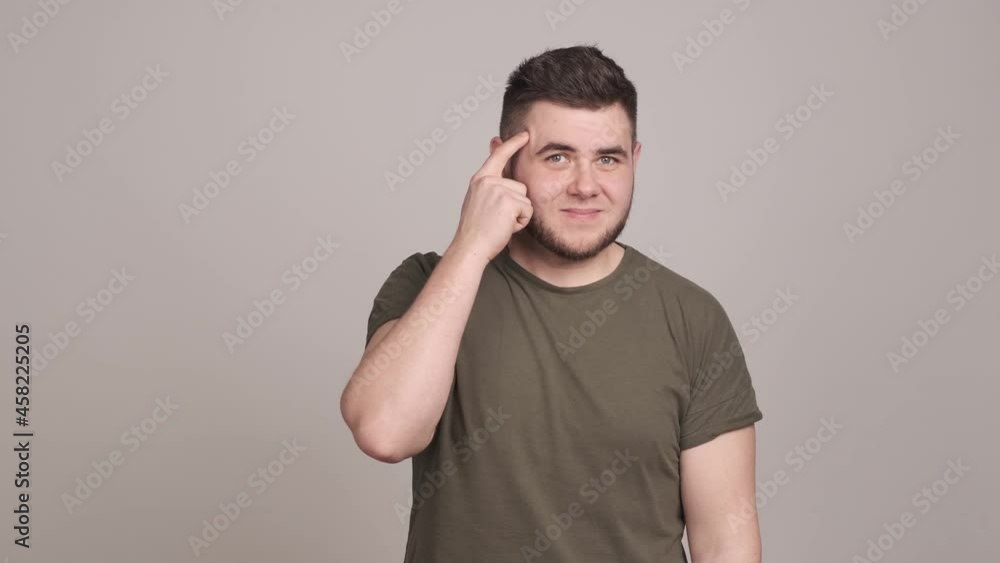 Annoyed guy displeased with crazy idea showing stupid gesture Annoyed guy displeased with crazy idea showing stupid gesture