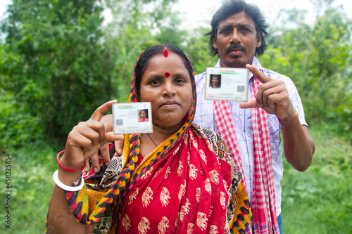 Photography Rural Villager Couple Showing Aadhaar Card  in agricultural field