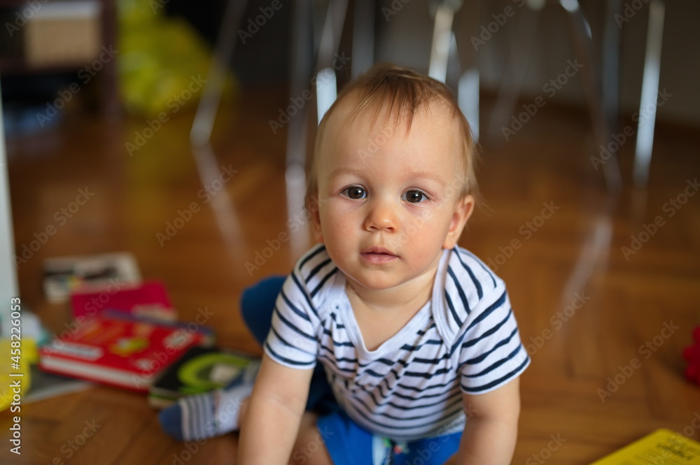 Adorable little baby playing on the floor Adorable little baby playing on the floor