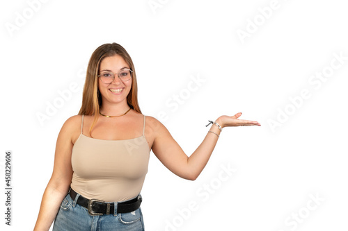 Young woman holding palm up looking at camera. White background. 20 - 22 years old. White European woman.