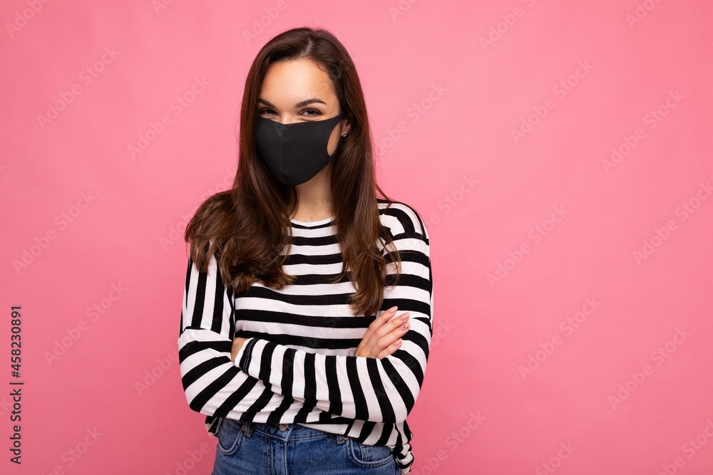 Photo of young attractive woman wearing handmade cotton fabric face mask isolated over colourful background wall. Protection against COVID-19 Photo of young attractive woman wearing handmade cotton fabric face mask isolated over colourful background wall. Protection against COVID-19