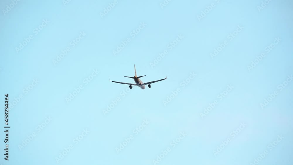Rear view of airplane taking off and ascending. Aircraft flying away. Travel concept. Plane takes off against cleat blue sky. Real time, telephoto perspective Rear view of airplane taking off and ascending. Aircraft flying away. Travel concept. Plane takes off against cleat blue sky. Real time, telephoto perspective