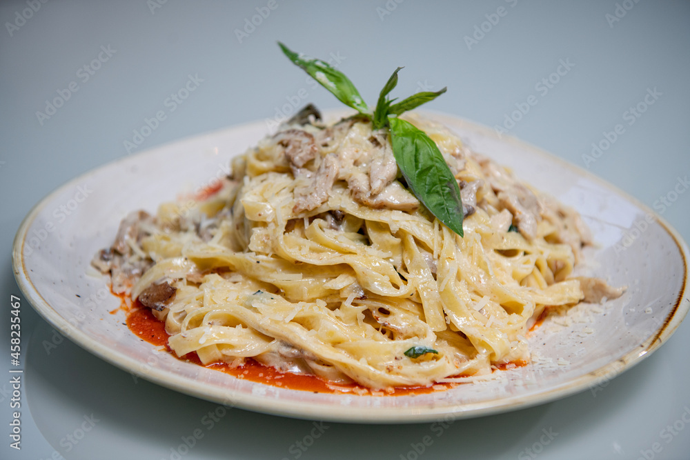 Penne pasta in tomato sauce and cheese decorated with basil on a wooden background, top view Penne pasta in tomato sauce and cheese decorated with basil on a wooden background, top view