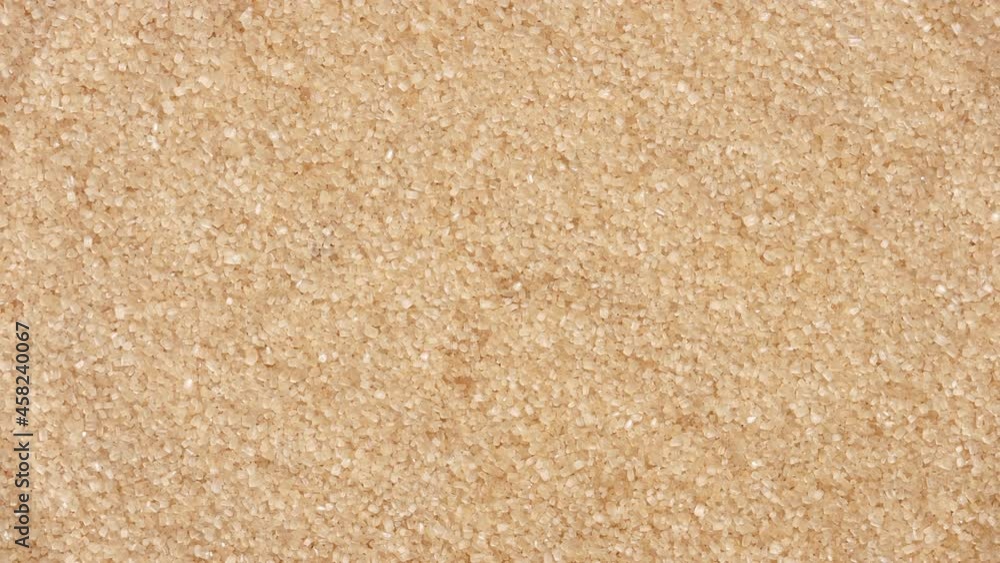 Water drop making water ripples on water surface against brown sugar crystals background | product background, moisturizing foundation commercial Water drop making water ripples on water surface against brown sugar crystals background | product background, moisturizing foundation commercial