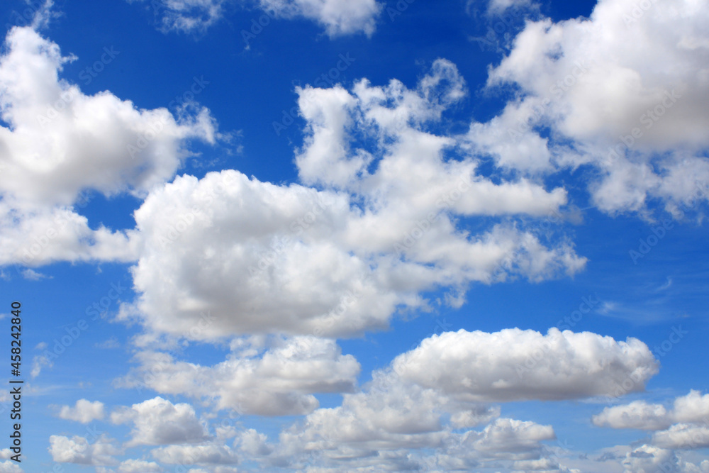 Fototapeta premium Clouds scattered over an intense blue sky