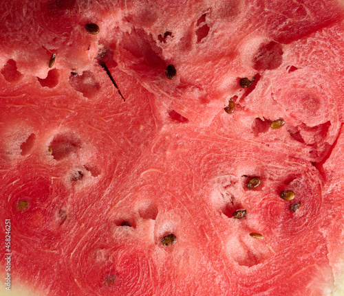 texture of ripe red watermelon with brown seeds, full frame, close up