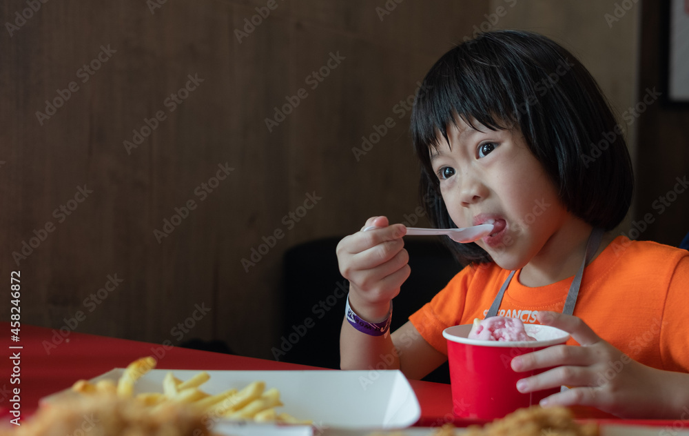 kid eating ice cream, delicious and happy concept
kid eating ice cream, delicious and happy concept