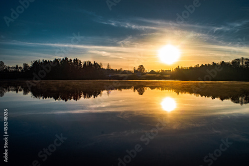 Sunrise over the river with a beautiful mirror-like reflection © Virgilijus