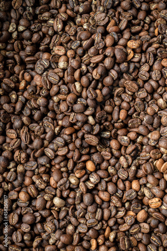 Coffee beans mocha coffee drink macro on brown concrete textured background.