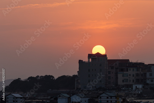 The harbor under the setting sun  the red and round sun