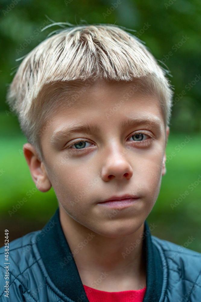 Portrait of caucasian kid in park looking to camera. Outdoor portrait of ten years old boy Portrait of caucasian kid in park looking to camera. Outdoor portrait of ten years old boy