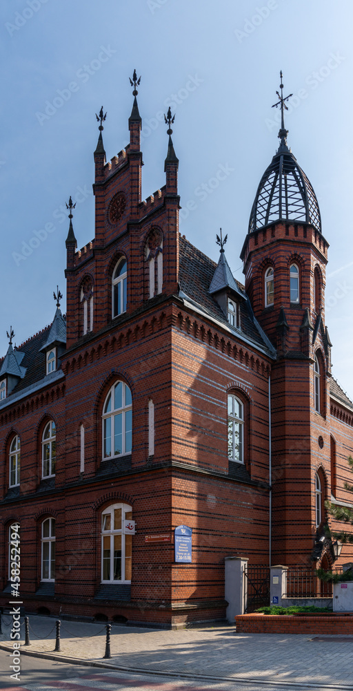 historic red brick Gothic architecture building in downtown Gniezno