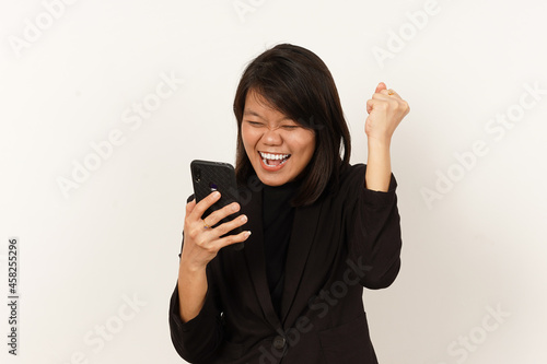 Beautiful Asian Woman Wearing black suit Happy while looking or using smartphone Isolated on white background