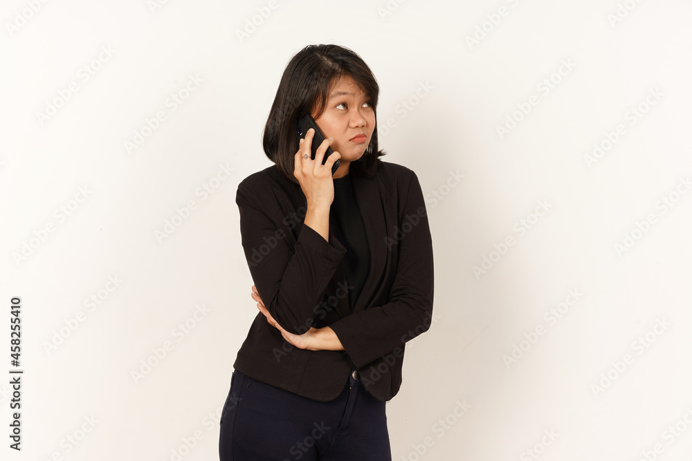 Beautiful Asian Woman Wearing black suit Talking on mobile phone with Serious facial expression Isolated on white background Beautiful Asian Woman Wearing black suit Talking on mobile phone with Serious facial expression Isolated on white background