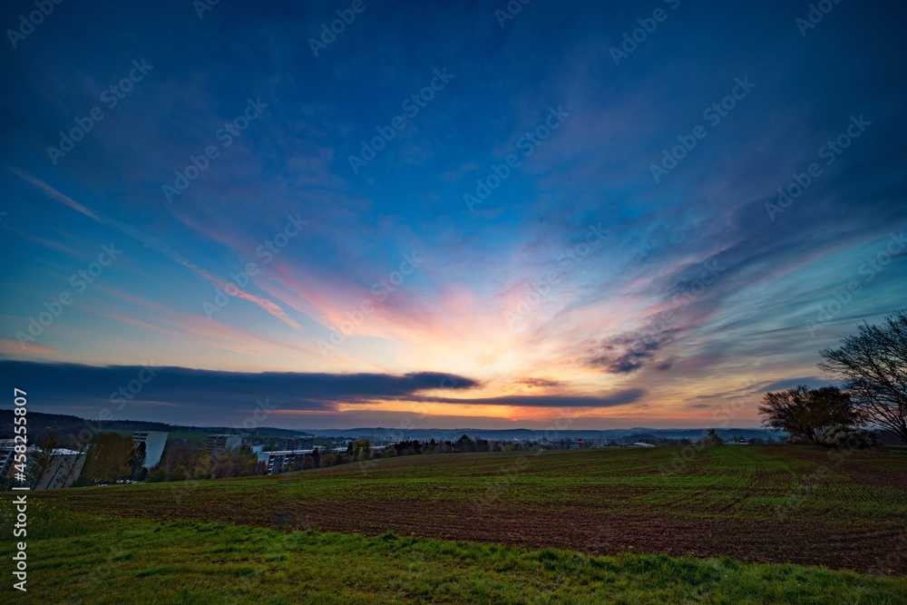 Panoramic sunrise over a green field