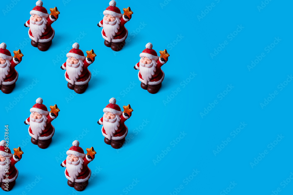 Christmas pattern of Santa Claus on blue background with copy space. Minimal pattern.